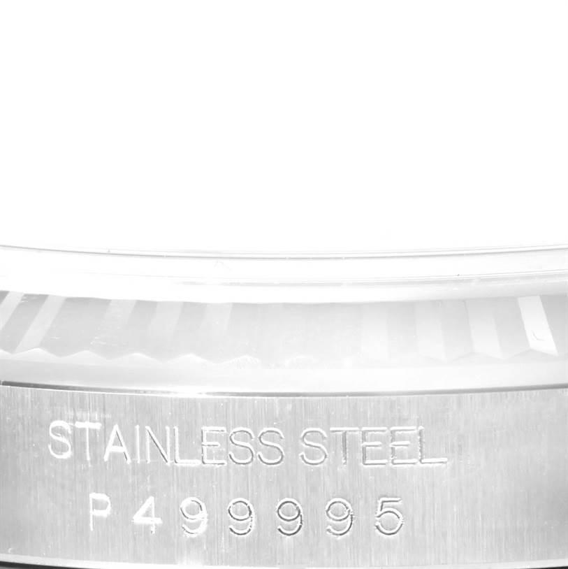 The image shows a close-up of the stainless steel case back of a Rolex Datejust 16234 Men
s Stainless Steel White Dial 16234 Men
s Stainless Steel White Dial watch, displaying a portion of the case
s serial number.