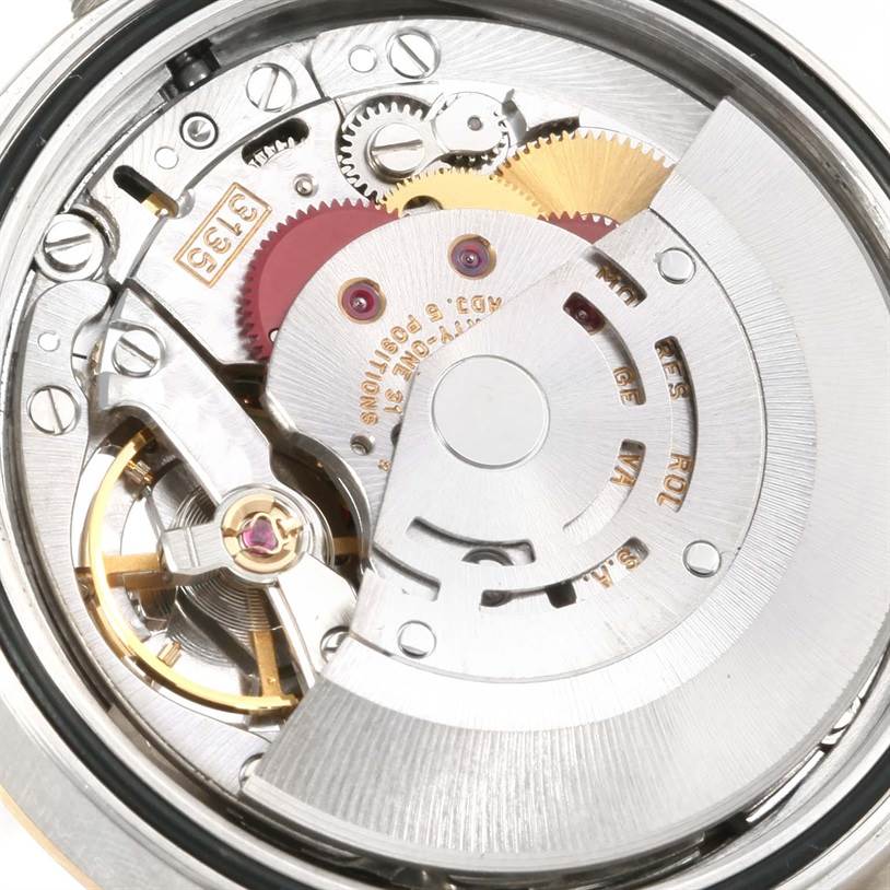 This is a close-up view of the Rolex Datejust 16233 Men's Steel and Gold (two tone) Champagne Dial 16233 Men's Steel and Gold (two tone) Champagne Dial movement, showcasing gears and internal mechanical parts.