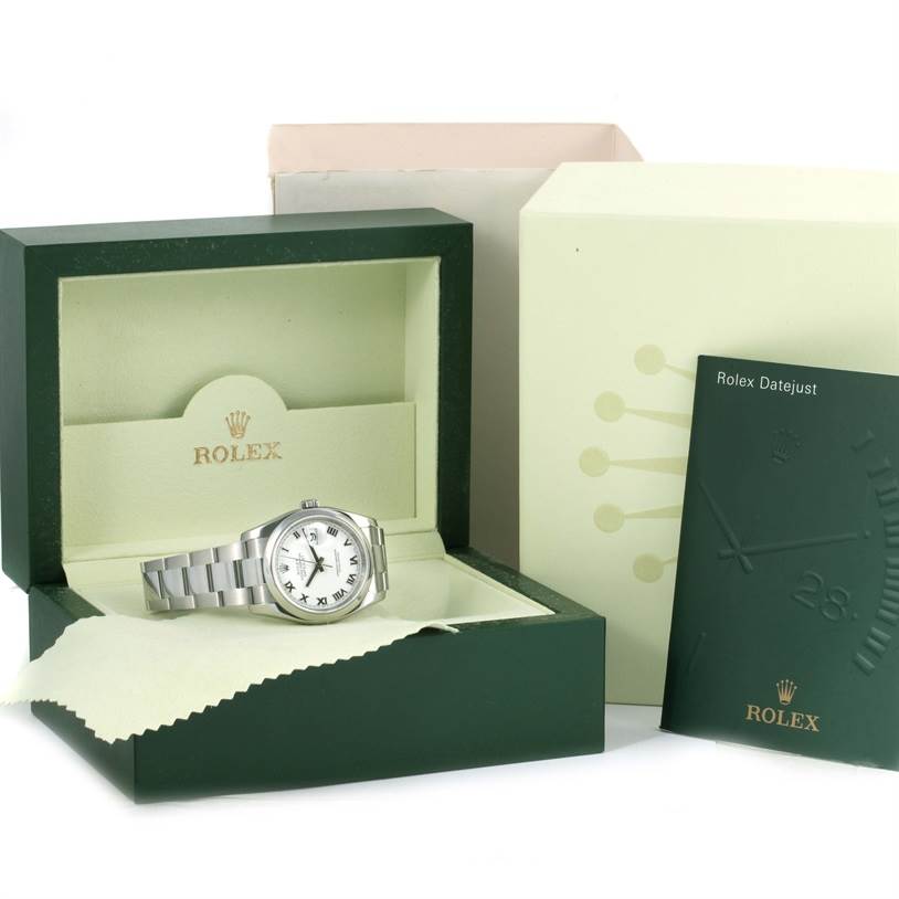 The image shows a Rolex Datejust 116200 Men
s Stainless Steel White Dial 116200 Men
s Stainless Steel White Dial watch in its open box with a booklet, outer box, and a cleaning cloth.