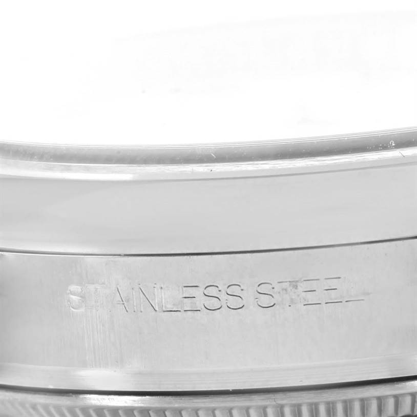 The image shows a close-up of the stainless steel casing of a Rolex Datejust 116200 Men
s Stainless Steel White Dial 116200 Men
s Stainless Steel White Dial watch.