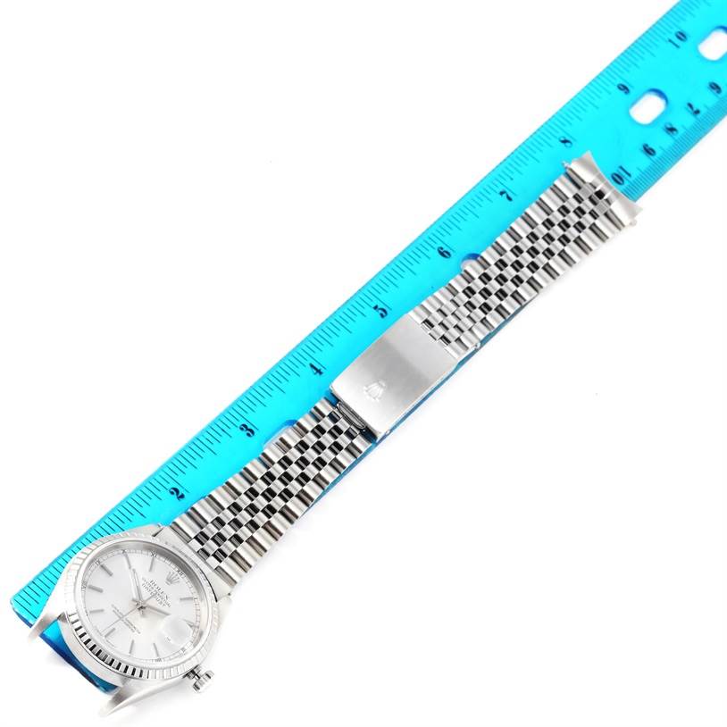 This image shows a top-down view of a Rolex Datejust 16220 Men
s Stainless Steel Silver Dial 16220 Men
s Stainless Steel Silver Dial watch with a ruler and the full length of the bracelet.