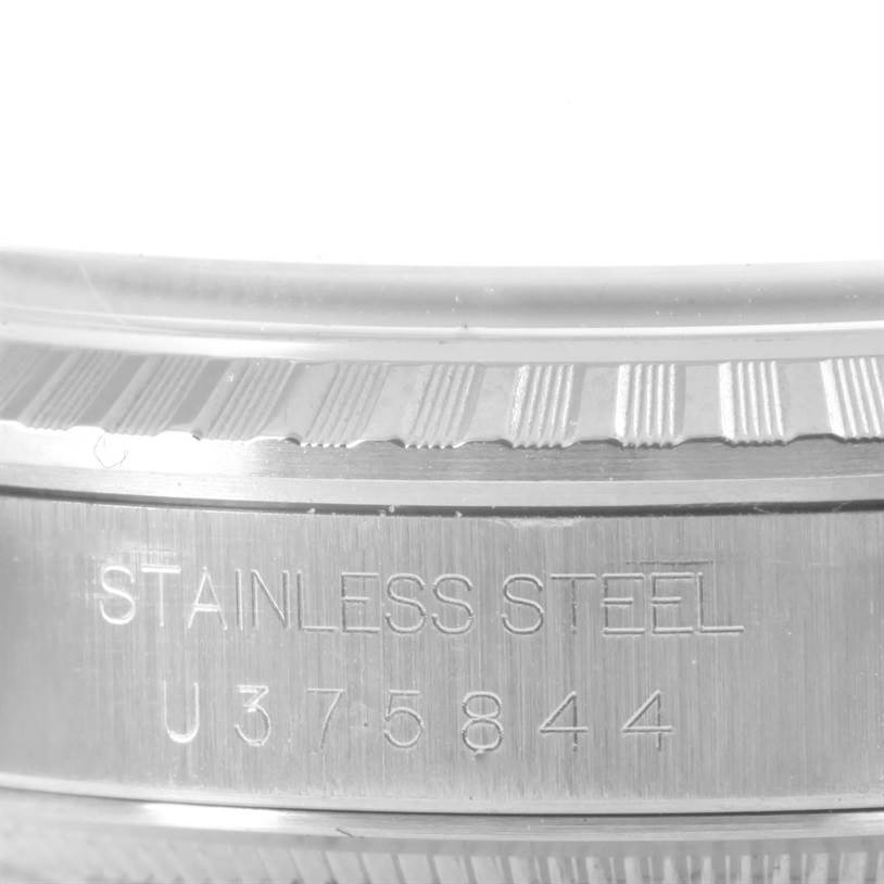 The image shows a close-up of the stainless steel bezel and casing of a Rolex Datejust 16220 Men
s Stainless Steel Silver Dial 16220 Men
s Stainless Steel Silver Dial watch.