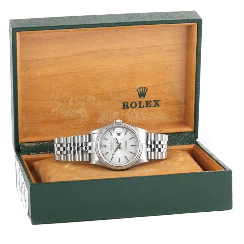 The image shows a frontal view of a Rolex Datejust 16220 Men
s Stainless Steel Silver Dial 16220 Men
s Stainless Steel Silver Dial watch displayed inside an open green and wooden Rolex box.
