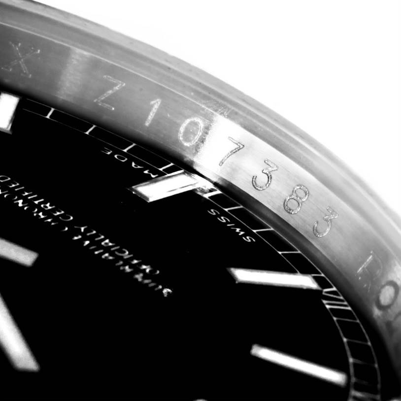 This image shows a close-up angle of the serial number engraved on the bezel and part of the dial of a Rolex Datejust 116234 Men
s Stainless Steel Black Dial 116234 Men
s Stainless Steel Black Dial watch.