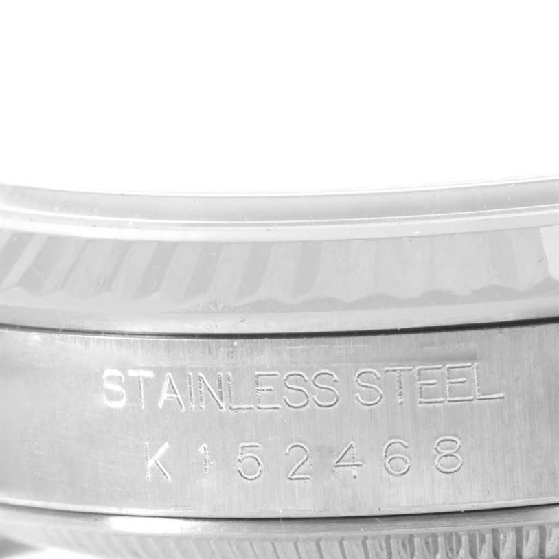 This image shows a close-up of the side of a Rolex Datejust 16234 Men
s Stainless Steel White Dial 16234 Men
s Stainless Steel White Dial watch, focusing on the engraving "STAINLESS STEEL" and serial number "K152468".