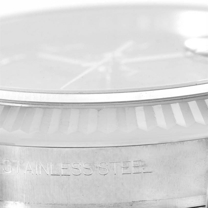 This close-up image shows the bezel, glass, and part of the case of the Rolex Datejust 116234 Men
s Stainless Steel Black Dial 116234 Men
s Stainless Steel Black Dial watch in stainless steel.