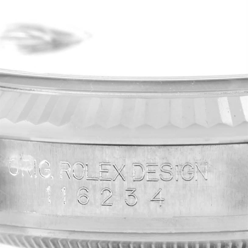 The image shows a close-up of the side of the Rolex Datejust 116234 Men
s Stainless Steel Black Dial 116234 Men
s Stainless Steel Black Dial watch bezel with the serial number engraved.