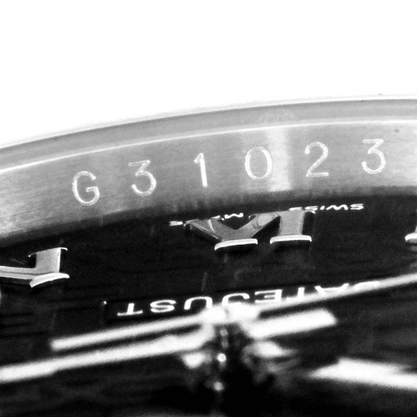 This image shows a close-up of the serial number "G31023" on the Rolex Datejust 116234 Men
s Stainless Steel Black Dial 116234 Men
s Stainless Steel Black Dial model watch, emphasizing the dial and engraved details.