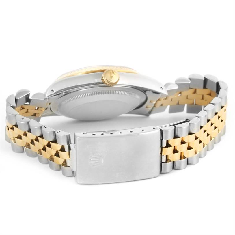 This image shows the back case, crown, and clasp of a Rolex Datejust 16233 Men
s Steel and Gold (two tone) Champagne Dial 16233 Men
s Steel and Gold (two tone) Champagne Dial watch with a two-tone bracelet.