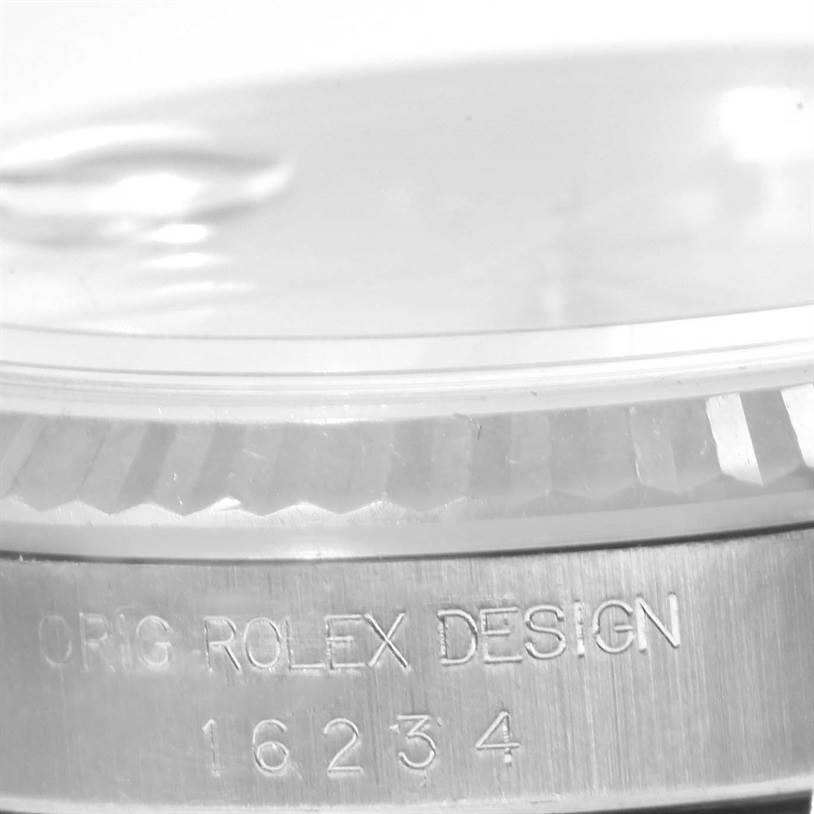 The image shows a close-up view of the case side and fluted bezel of a Rolex Datejust 16234 Men's Stainless Steel Silver Dial 16234 Men's Stainless Steel Silver Dial model, featuring the engraving "ORIG ROLEX DESIGN 16234".