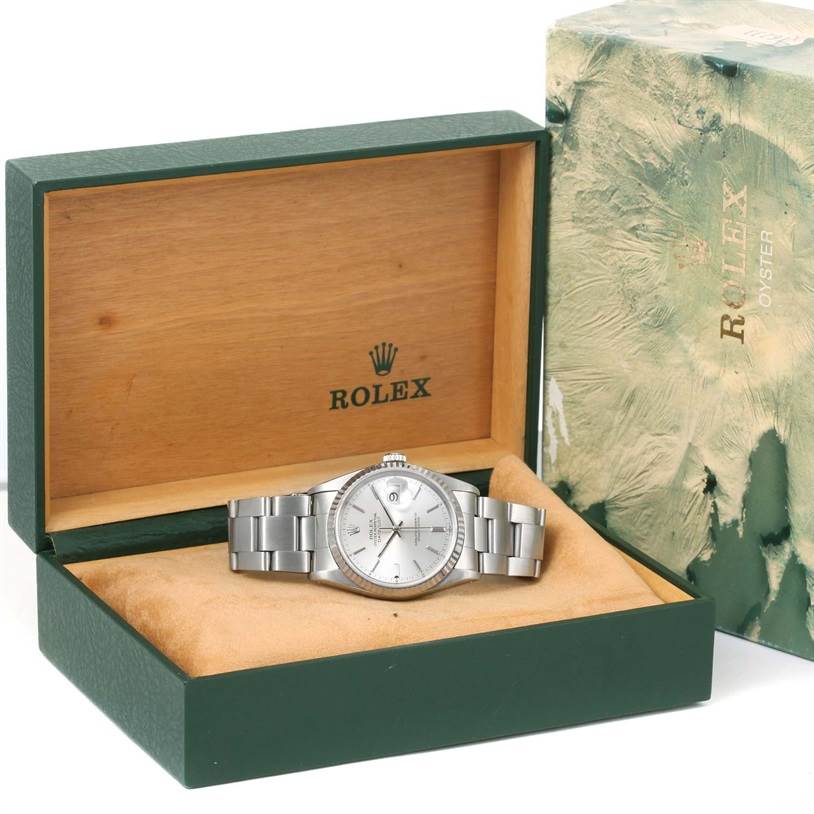 The Rolex Datejust 16234 Men's Stainless Steel Silver Dial 16234 Men's Stainless Steel Silver Dial watch is shown from an angled front view inside its open green and wooden box, with its outer box beside it.