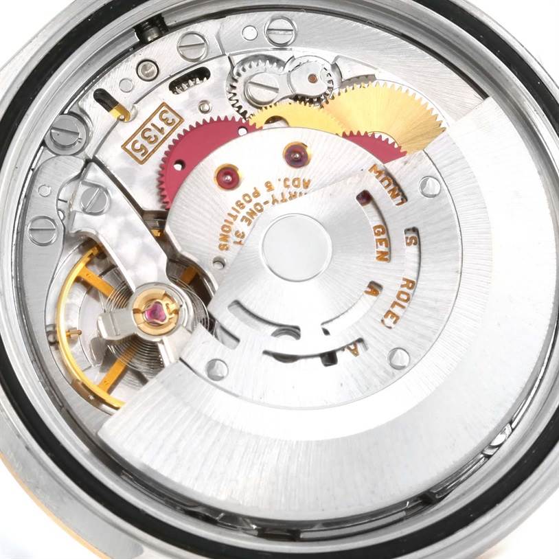 The image shows the internal movement and gears of the Rolex Datejust 16233 Men
s Steel and Gold (two tone) Beige Dial 16233 Men
s Steel and Gold (two tone) Beige Dial watch from a top-down angle.