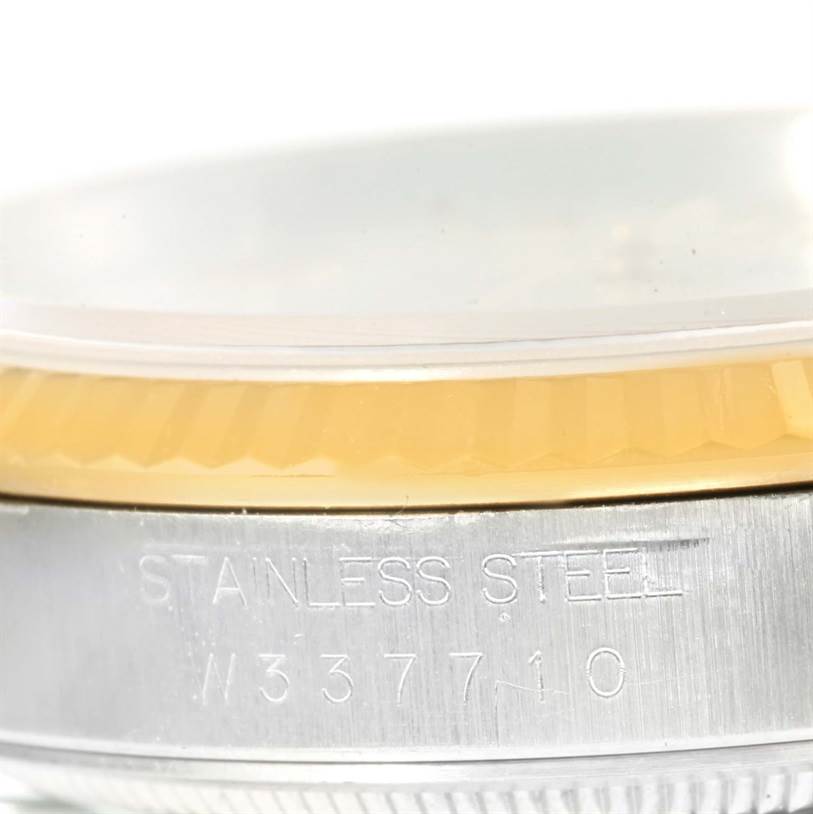 This image shows a close-up angle of the case side and bezel of a Rolex Datejust 16233 Men
s Steel and Gold (two tone) Beige Dial 16233 Men
s Steel and Gold (two tone) Beige Dial, highlighting the stainless steel engraving.