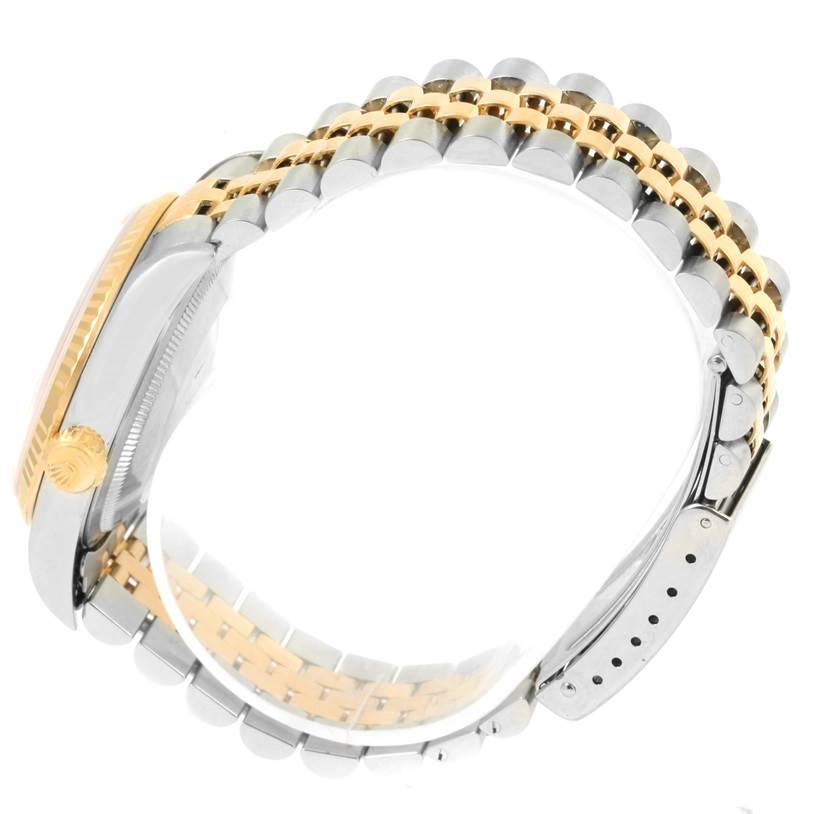 This image shows a side angle of the Rolex Datejust 16233 Men
s Steel and Gold (two tone) Beige Dial 16233 Men
s Steel and Gold (two tone) Beige Dial watch, highlighting the crown, case, and two-tone bracelet.