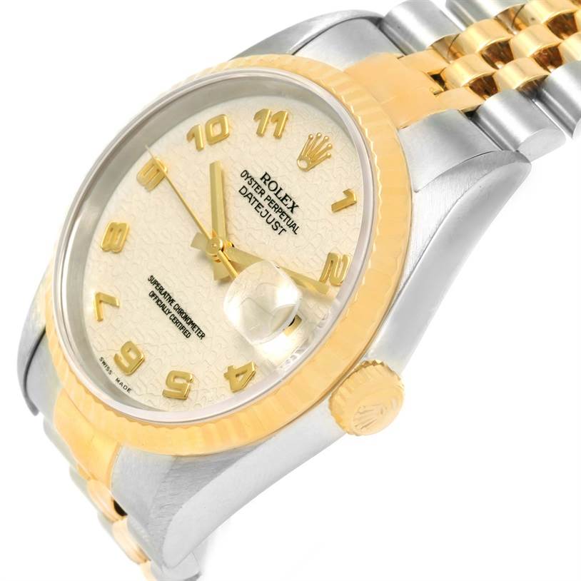 The image shows a close-up angle of a Rolex Datejust 16233 Men
s Steel and Gold (two tone) Beige Dial 16233 Men
s Steel and Gold (two tone) Beige Dial watch, highlighting its gold and silver bracelet, crown, and dial with date magnifier.