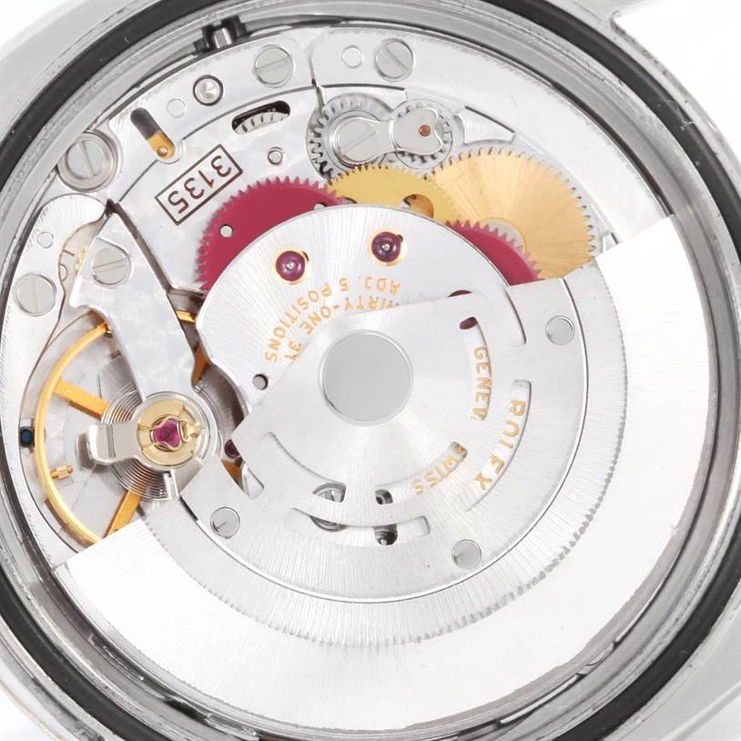 This image shows the intricate inner mechanism of a Rolex Datejust 116234 Men
s Stainless Steel Black Dial 116234 Men
s Stainless Steel Black Dial watch, focusing on its gears and movement components.