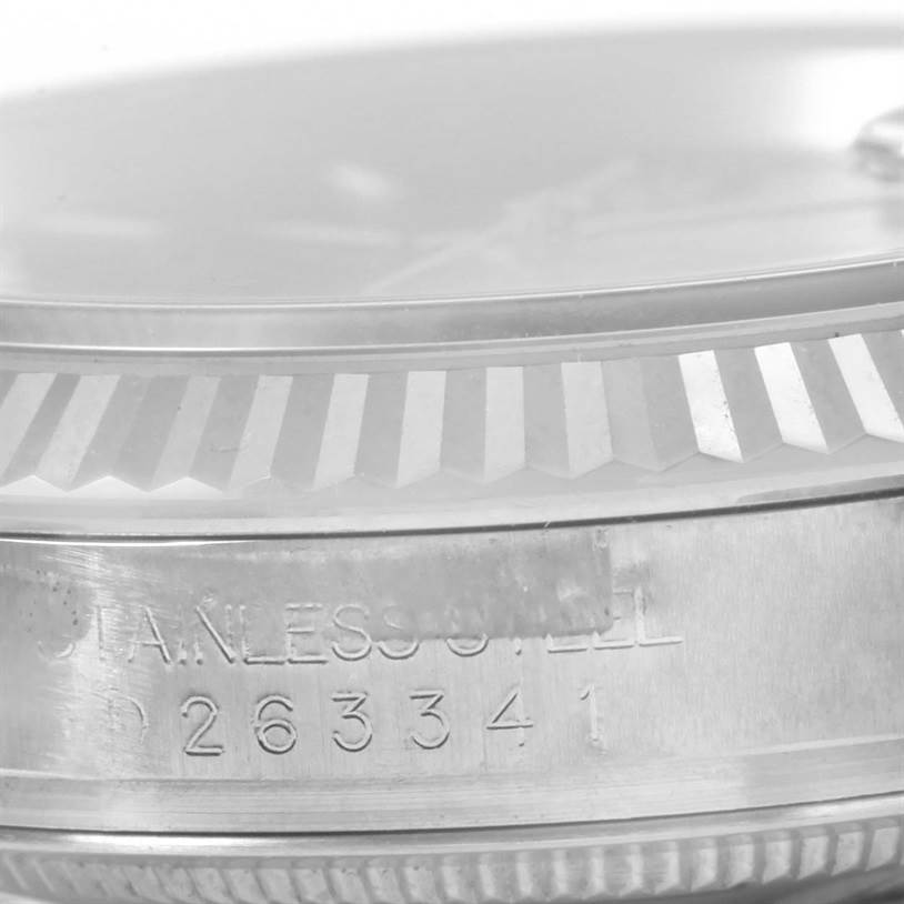 This close-up image shows the side view of the stainless steel case and fluted bezel of the Rolex Datejust 116234 Men
s Stainless Steel Black Dial 116234 Men
s Stainless Steel Black Dial watch, with part of the serial number visible.