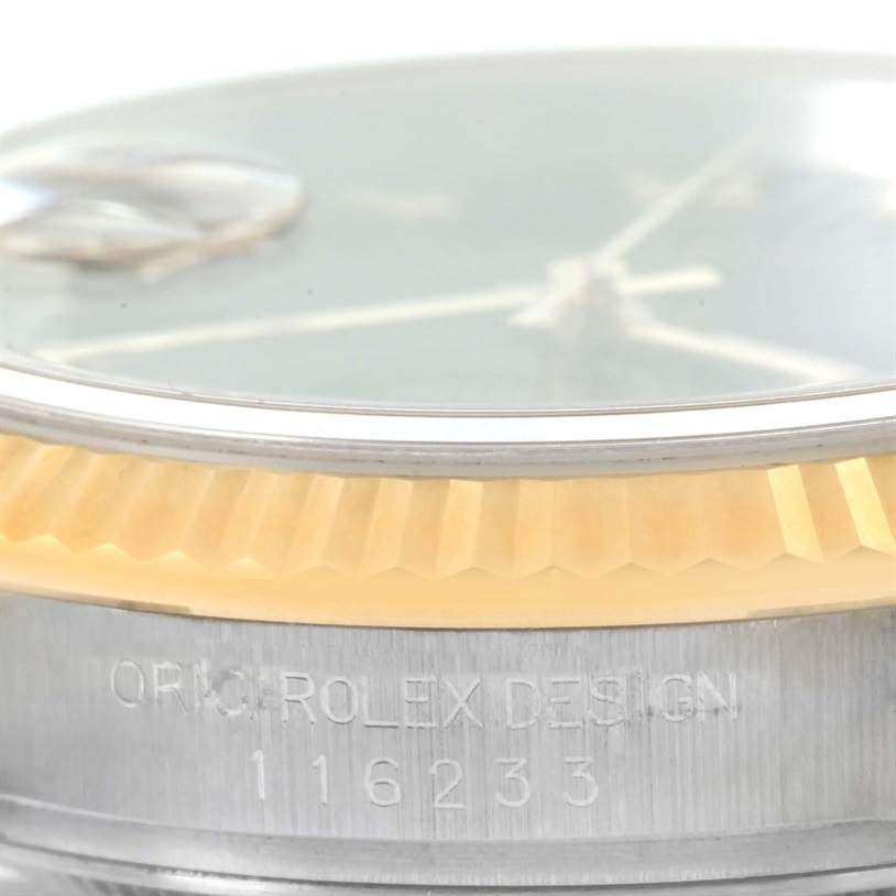 The image shows a close-up of the bezel, part of the dial, and the case with the engraved serial number of a Rolex Datejust 116233 Men
s Stainless Steel Black Dial 116233 Men
s Stainless Steel Black Dial watch.