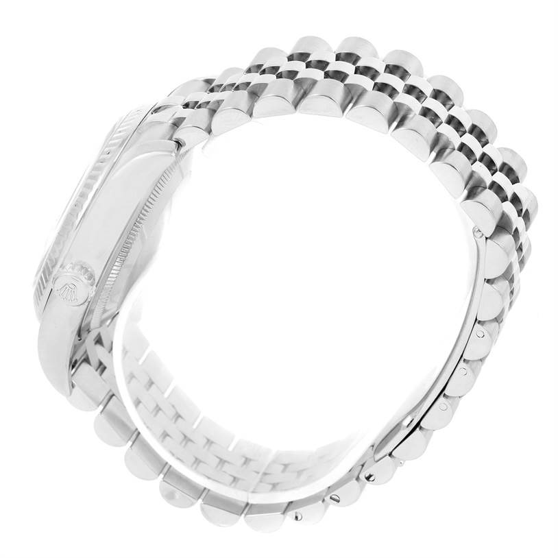 The image shows a side view of the Rolex Datejust 116234 Men
s Stainless Steel Black Dial 116234 Men
s Stainless Steel Black Dial watch, focusing on its bezel, case, and Jubilee bracelet.