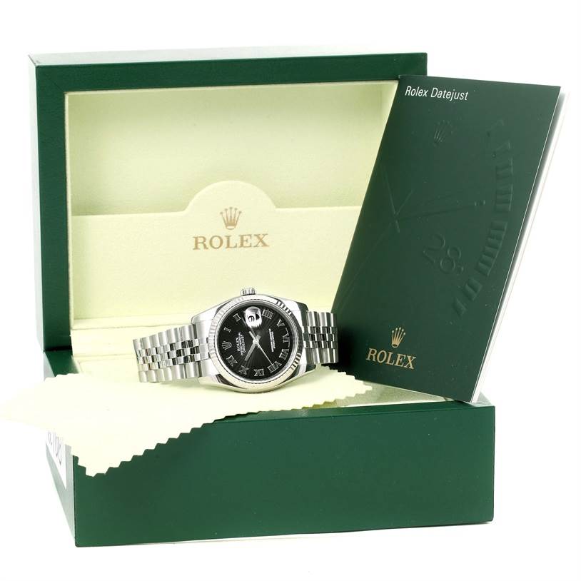 The image shows a Rolex Datejust 116234 Men
s Stainless Steel Black Dial 116234 Men
s Stainless Steel Black Dial watch at a front angle, placed in an open box with its booklet displayed.