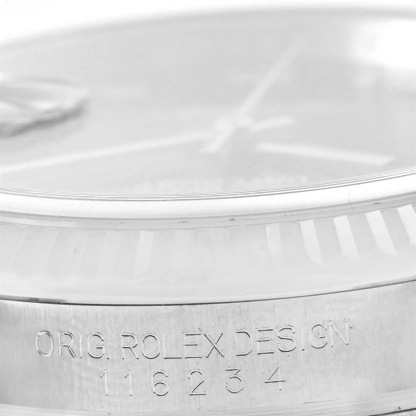 The image shows a close-up of a Datejust model by Rolex, focusing on the dial, bezel, and engraved case details.