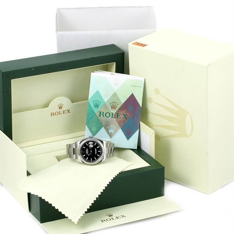 The image shows a Rolex Datejust 116200 Men
s Stainless Steel Black Dial 116200 Men
s Stainless Steel Black Dial watch in its box with manuals and a cleaning cloth.