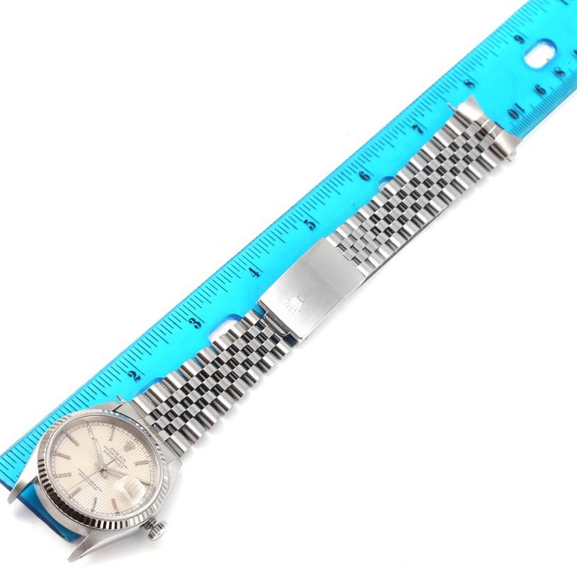 The image shows a top-down view of a Rolex Datejust 16234 Men's Stainless Steel Silver Dial 16234 Men's Stainless Steel Silver Dial watch, highlighting the face, bezel, and bracelet, measured alongside a blue ruler.