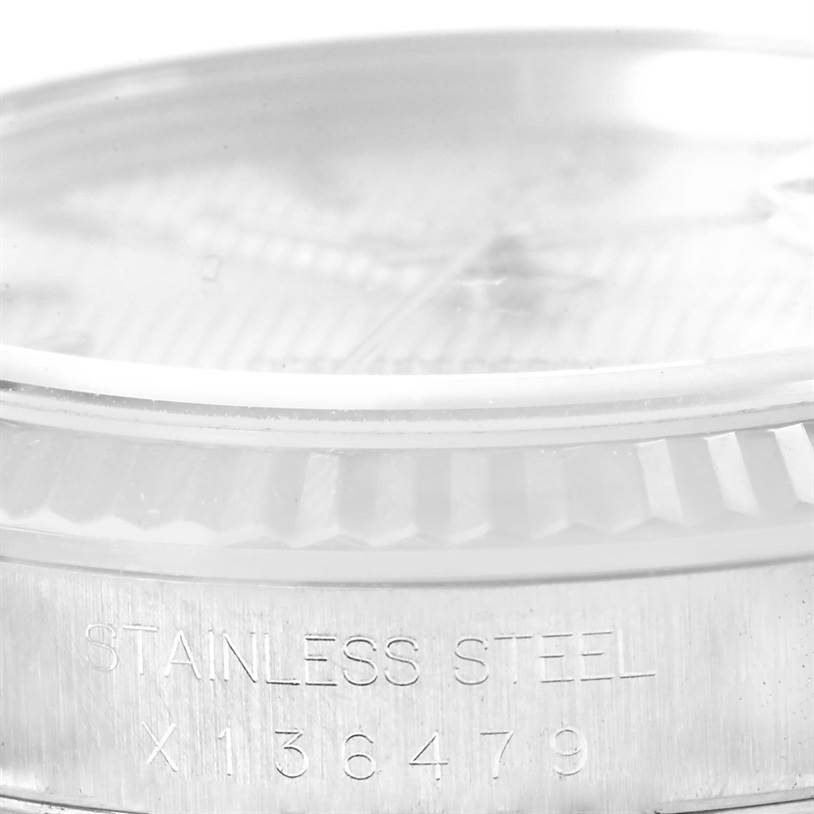 This close-up image shows the stainless steel engraving and part of the bezel of a Rolex Datejust 16234 Men's Stainless Steel Silver Dial 16234 Men's Stainless Steel Silver Dial watch.
