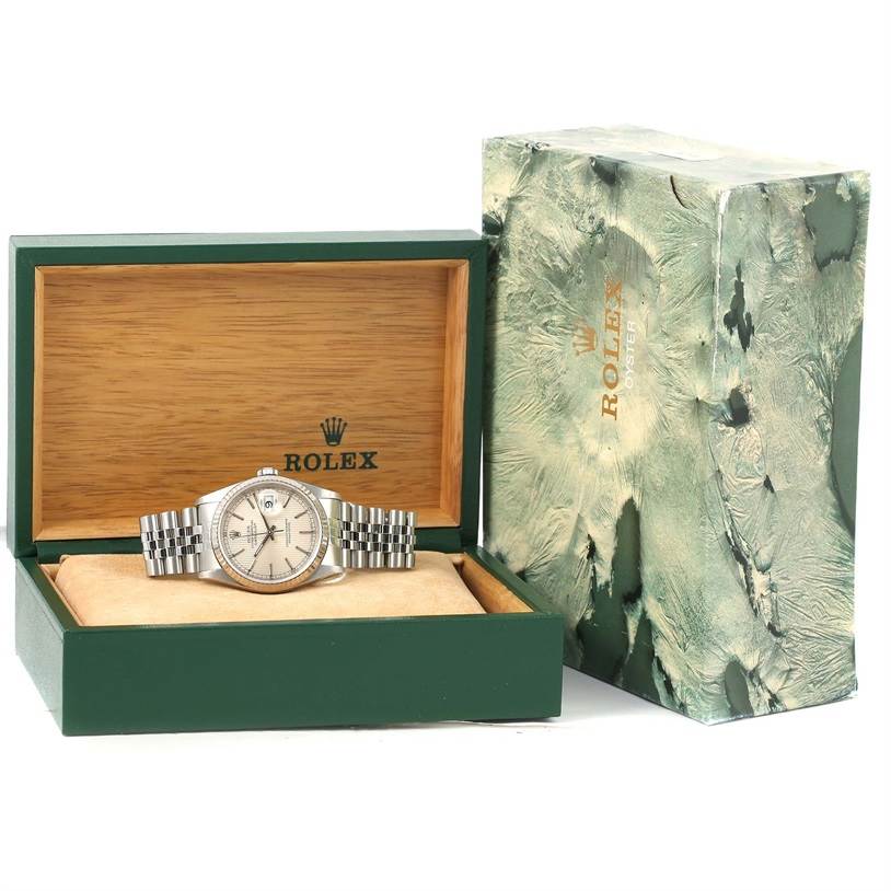The image shows a Rolex Datejust 16234 Men's Stainless Steel Silver Dial 16234 Men's Stainless Steel Silver Dial watch from a front-angle, displayed in an open green box with a marbled outer packaging beside it.