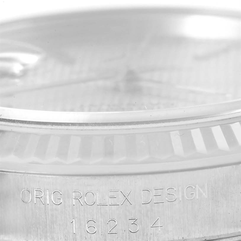 This image shows a close-up of the bezel and engraving of a Rolex Datejust 16234 Men's Stainless Steel Silver Dial 16234 Men's Stainless Steel Silver Dial watch, highlighting the "ORIG ROLEX DESIGN 16234" text.