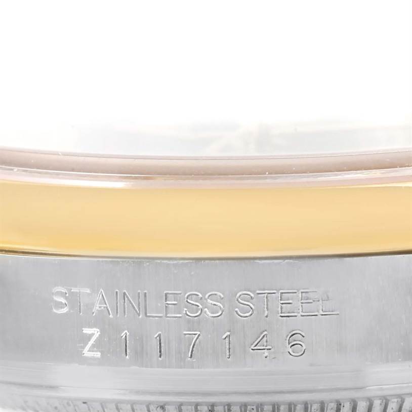 This image shows a close-up view of the stainless steel case of a Rolex Datejust 116203 Men's Stainless Steel Grey Dial 116203 Men's Stainless Steel Grey Dial watch, including its serial number.