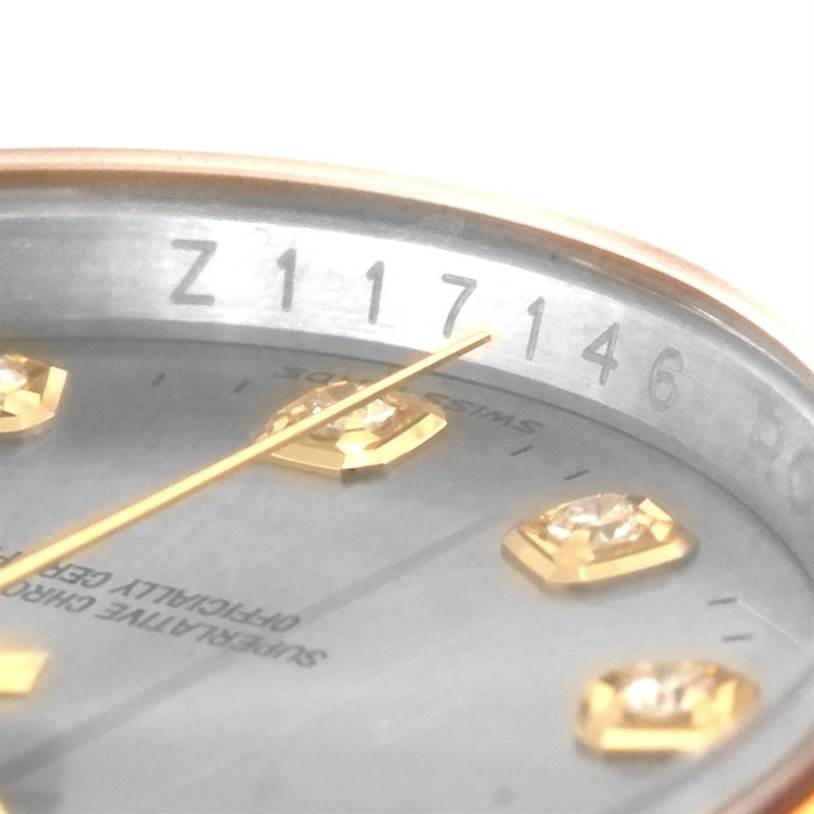 The image shows a close-up of the Rolex Datejust 116203 Men's Stainless Steel Grey Dial 116203 Men's Stainless Steel Grey Dial watch dial and part of the serial number on the inner bezel.