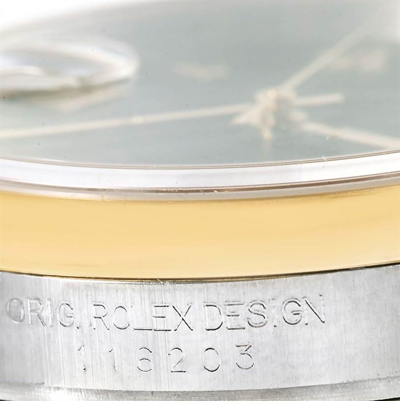 Close-up of the side of a Datejust Rolex watch showing part of the dial, bezel, and engraved reference number.