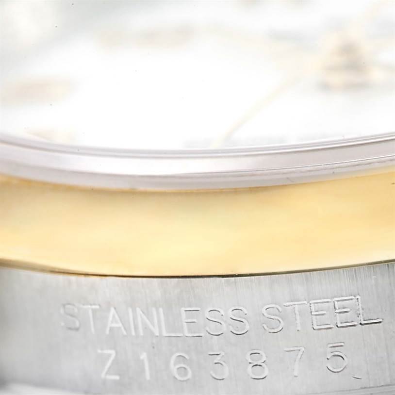 This image shows a close-up of the serial number and "STAINLESS STEEL" engraving on the Rolex Datejust 116203 Men's Stainless Steel White Dial 116203 Men's Stainless Steel White Dial watch case.