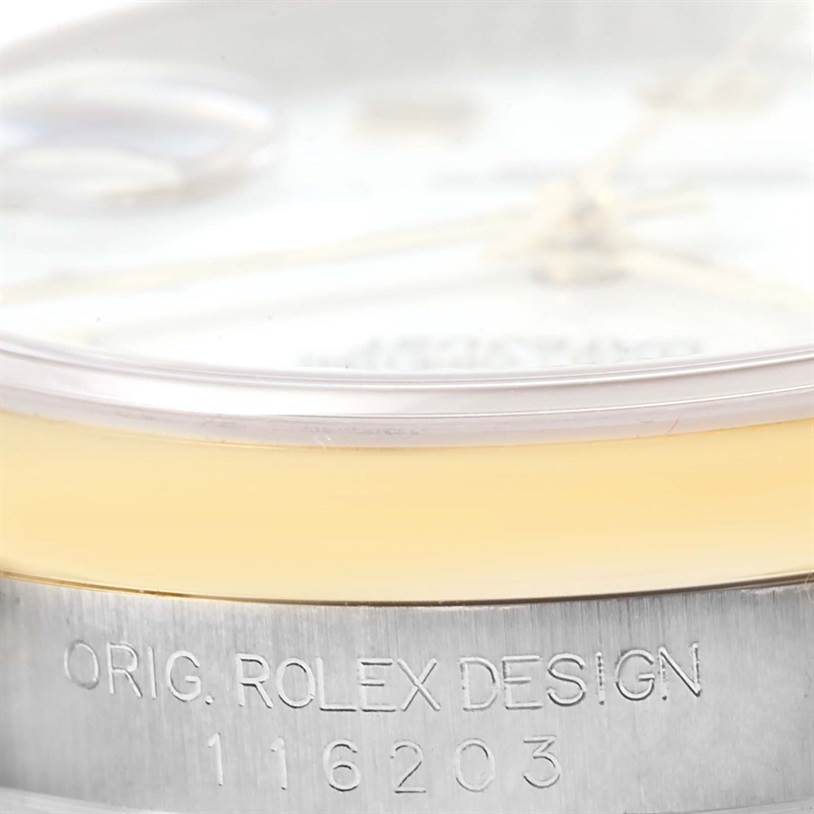 This close-up image shows the side of a Rolex Datejust 116203 Men's Stainless Steel White Dial 116203 Men's Stainless Steel White Dial watch, focusing on the crystal, bezel, and case with engraved model number.