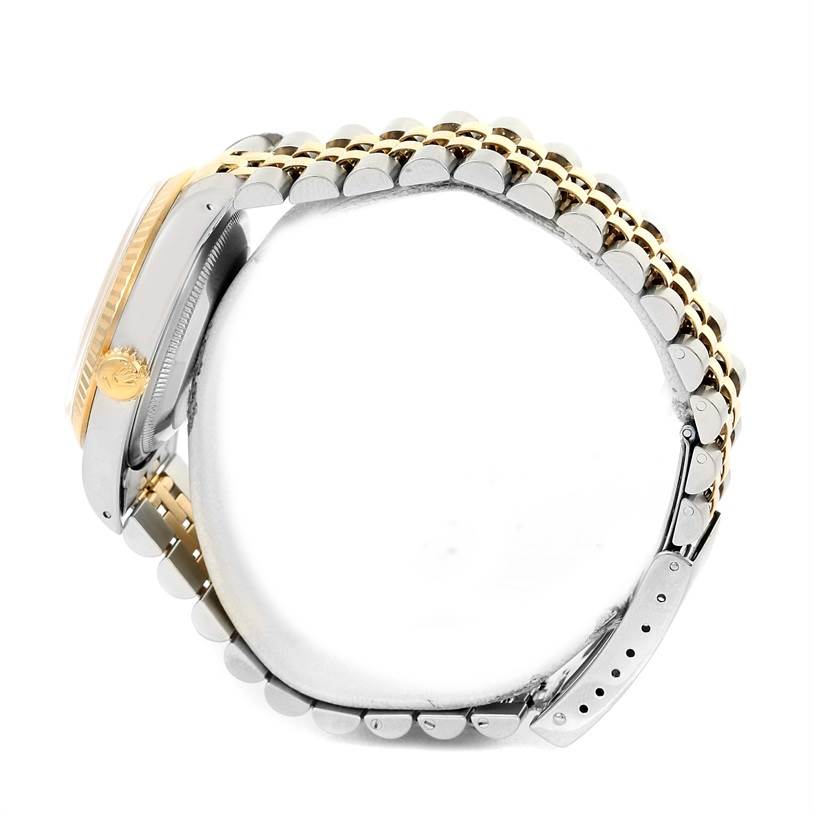 This Rolex Datejust 16233 Men's Steel and Gold (two tone) Champagne Dial 16233 Men's Steel and Gold (two tone) Champagne Dial watch is shown from a side angle, highlighting the case, crown, and metal bracelet.