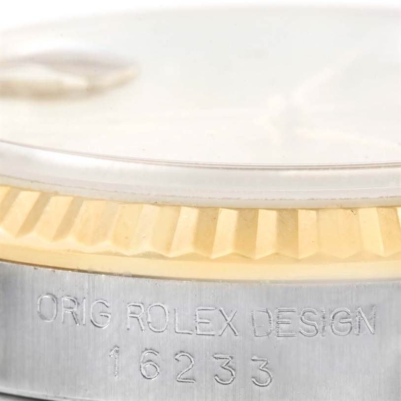 Close-up of a Rolex Datejust 16233 Men's Steel and Gold (two tone) Champagne Dial 16233 Men's Steel and Gold (two tone) Champagne Dial model showing the fluted bezel and engraved model number "16233" on the side.