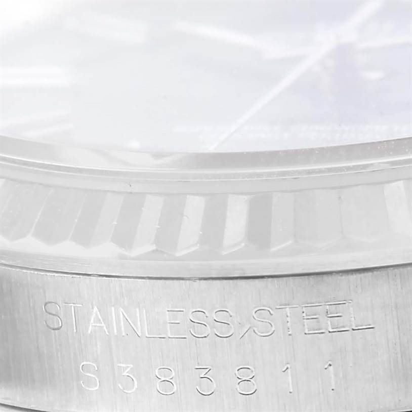 The image shows a close-up of the side of a Rolex Datejust 16234 Men's Stainless Steel Blue Dial 16234 Men's Stainless Steel Blue Dial watch, highlighting the stainless steel case and etched model number.