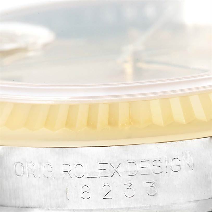 The image displays a close-up of the fluted bezel and casing of a Rolex Datejust 116233 Men's Stainless Steel Champagne Dial 116233 Men's Stainless Steel Champagne Dial watch, highlighting the engraved model number 16233.