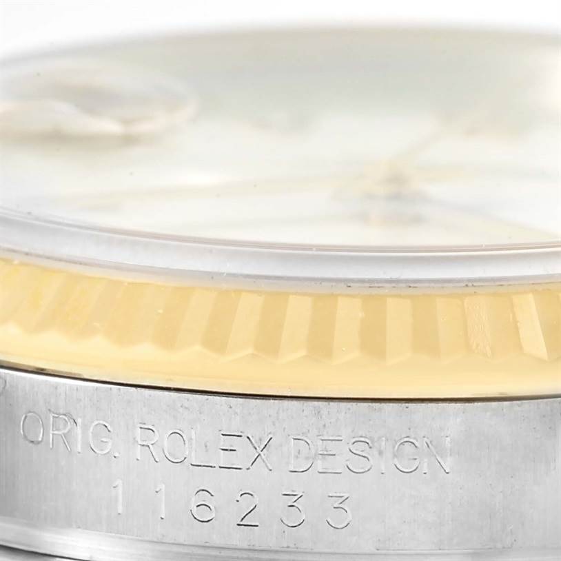 This image shows a close-up of the side of a Rolex Datejust 116233 Men's Stainless Steel White Dial 116233 Men's Stainless Steel White Dial watch, highlighting the bezel and part of the case with the model number engraved.