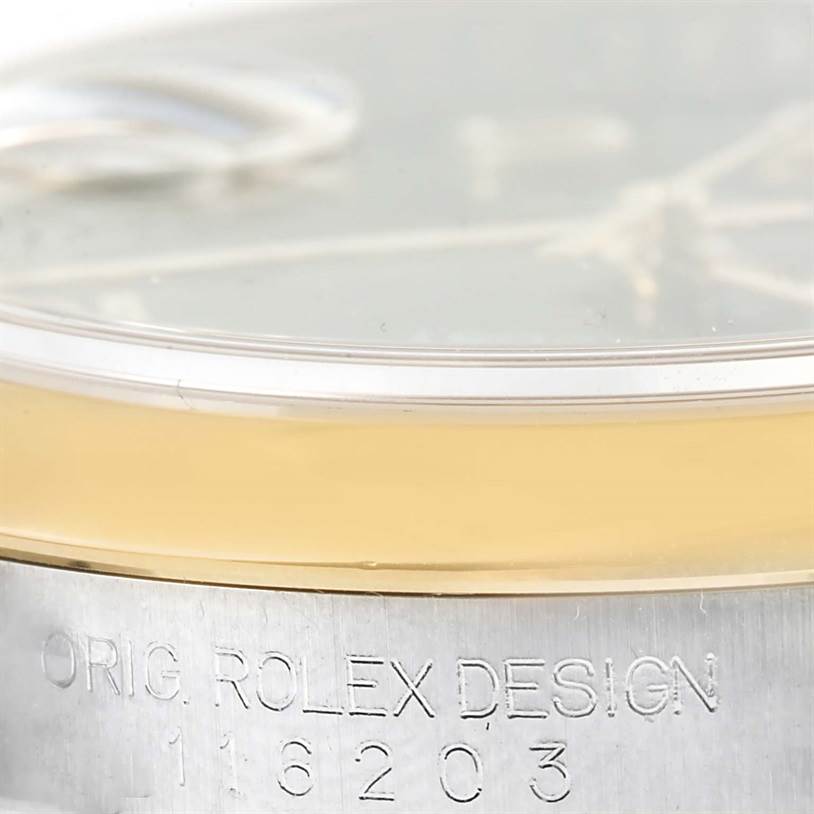 The image shows a close-up of the bezel and engraved case side of a Rolex Datejust 116203 Men's Stainless Steel Brown Dial 116203 Men's Stainless Steel Brown Dial watch, model number 116203.