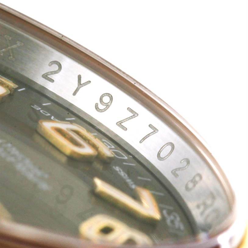 Close-up angle of a Rolex Datejust 116203 Men's Stainless Steel Brown Dial 116203 Men's Stainless Steel Brown Dial watch showing the engraved serial number inside the bezel.