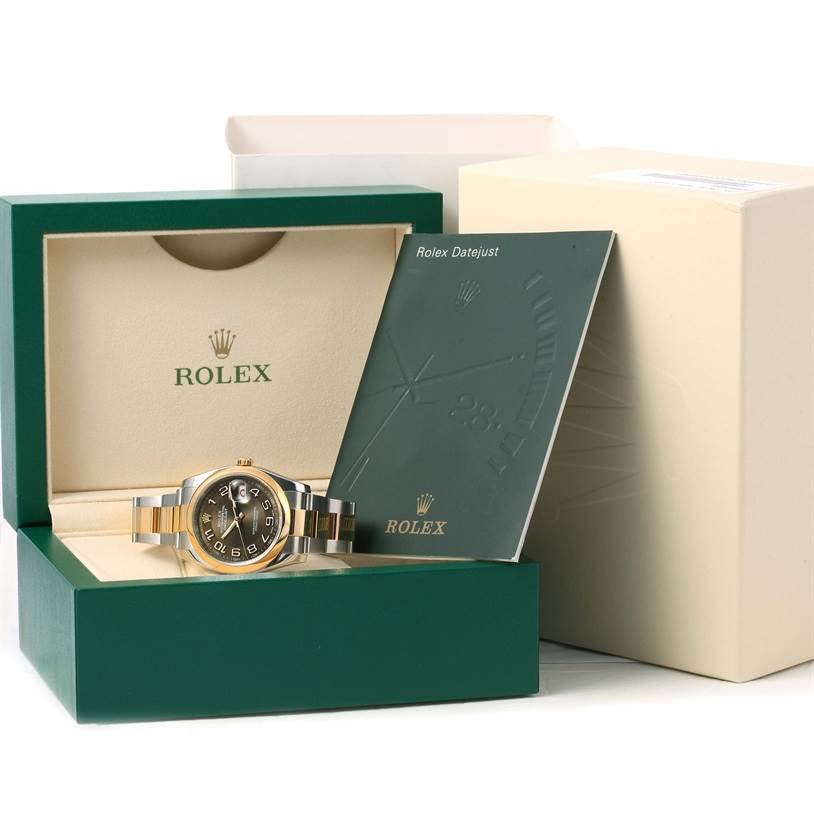 The Rolex Datejust 116203 Men's Stainless Steel Brown Dial 116203 Men's Stainless Steel Brown Dial watch is shown inside its open green box with a booklet and outer packaging in the background.