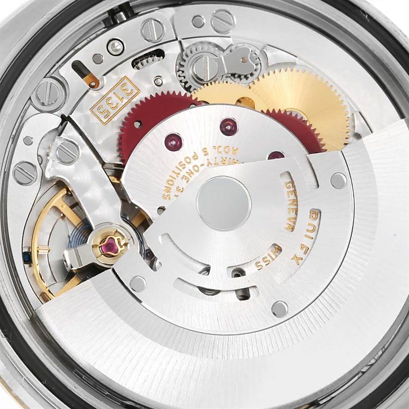 This is an internal view of the Rolex Datejust 116203 Men's Stainless Steel Brown Dial 116203 Men's Stainless Steel Brown Dial watch showing the intricate movement mechanism and gears.