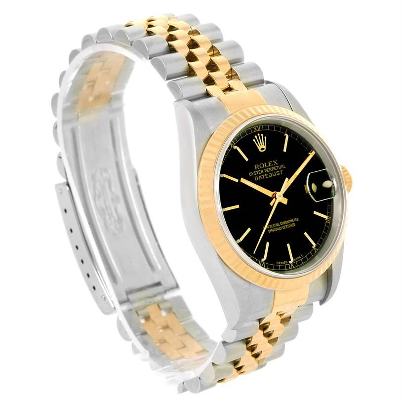The image shows a Rolex Datejust 16233 Men's Steel and Gold (two tone) Black Dial 16233 Men's Steel and Gold (two tone) Black Dial watch, featuring a black dial, fluted bezel, and two-tone bracelet, viewed from an angle highlighting the face and strap.