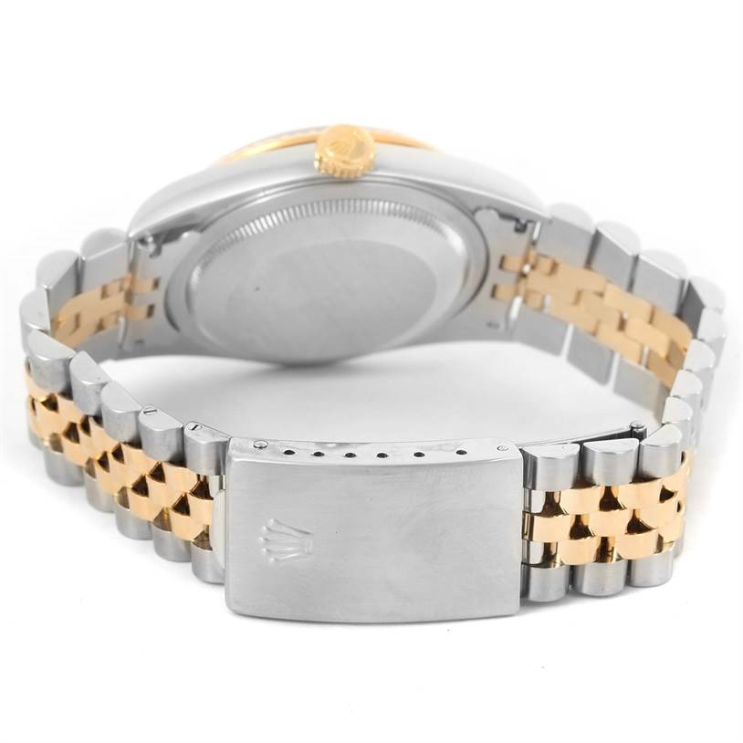 The Rolex Datejust 16233 Men's Steel and Gold (two tone) Black Dial 16233 Men's Steel and Gold (two tone) Black Dial watch is shown from the rear, highlighting its case back, crown, and two-tone metal bracelet.