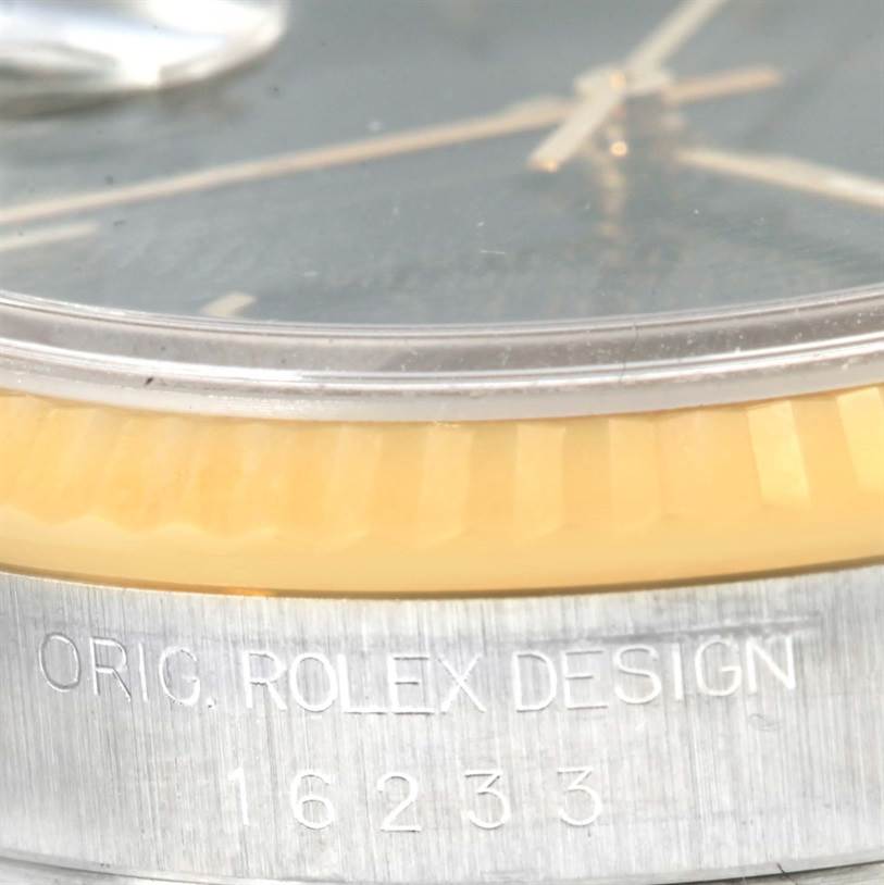 This close-up image shows the side of a Rolex Datejust 16233 Men's Steel and Gold (two tone) Black Dial 16233 Men's Steel and Gold (two tone) Black Dial watch, including the bezel and part of the dial with the model number.