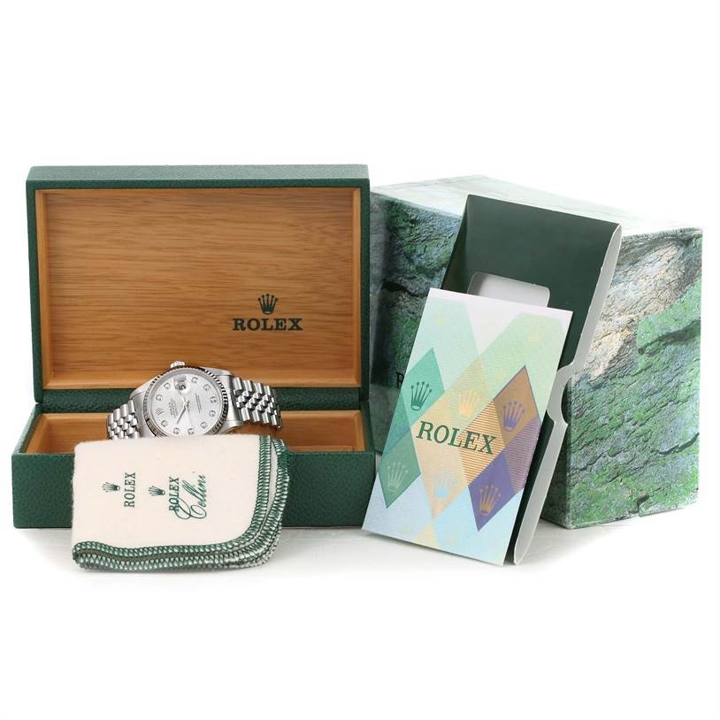 The Rolex Datejust 16234 Men's Stainless Steel Silver Dial 16234 Men's Stainless Steel Silver Dial watch is displayed in an open box with its accessories including a cleaning cloth and documents.