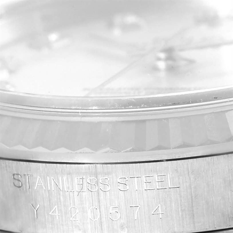 The image shows a close-up angle of the Rolex Datejust 16234 Men's Stainless Steel Silver Dial 16234 Men's Stainless Steel Silver Dial watch's bezel and serial number engraving on stainless steel.