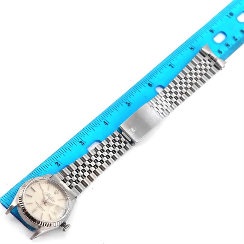 The image shows a Rolex Datejust 16234 Men's Stainless Steel Silver Dial 16234 Men's Stainless Steel Silver Dial watch laid flat with a ruler beside it, displaying the watch face and metal bracelet.